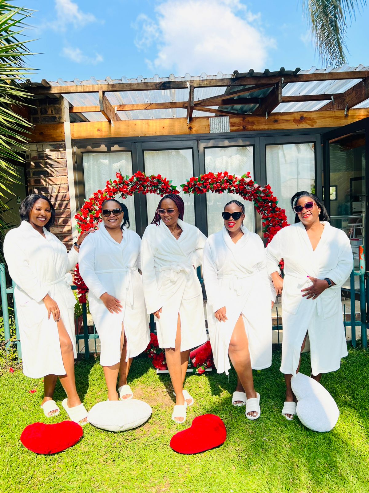 Five guests enjoying a group spa package in gowns.